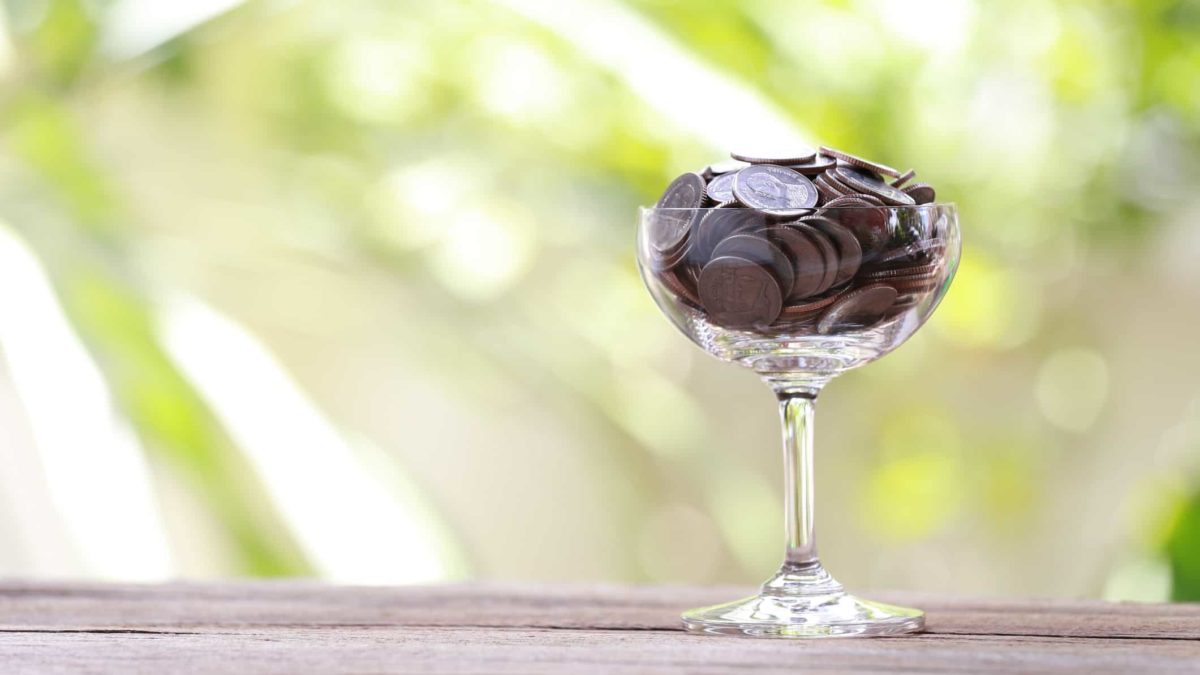 wine glass full of coins