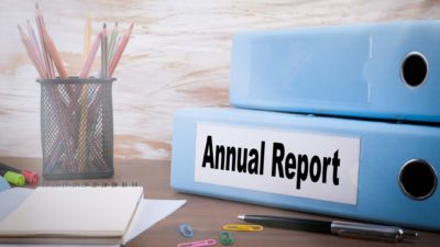 pencils, pen, note pad, paper clips and folder entitled annual report signifying asx reporting season