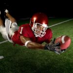 man scoring touchdown in football game