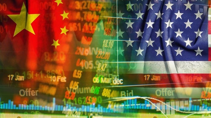 US and Chinese stocks charts against backdrops of national flags