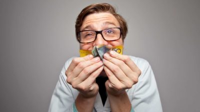 A man happily kisses a $50 note scrunched up in his hands representing the best ASX dividend stocks in Australia today