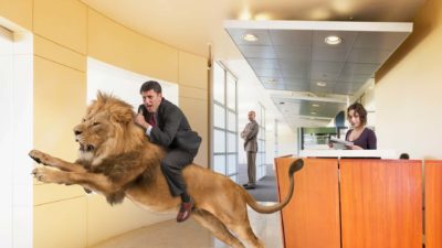 ASX share price rise represented by investor riding atop leaping lion