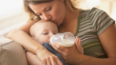 mother feeding her baby milk