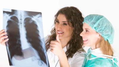 Two doctors give the thumbs up to an x-ray