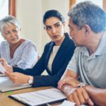 Young professional person providing advise to older couple.