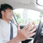 man happy while driving tesla