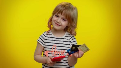 girl holding credit cards and phone