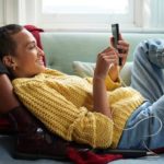 Woman relaxing and using her Apple device