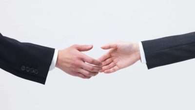 two hands about to shake, merger, acquisition, business deal