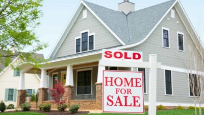 Home for sale and sold sign in front of property