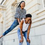 One girl leapfrogs over her friend's back.