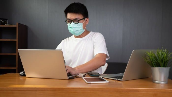 Man working with a mask on.