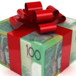 a Christmas present wrapped in one hundred dollar notes and finished with a big red bow