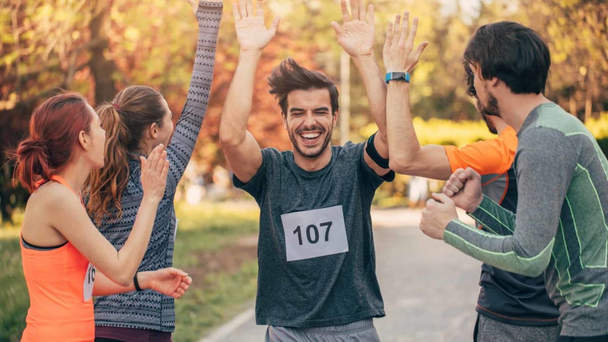 A runner high-fives as he crosses the finish line in pole position