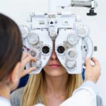 A women has her eyes checked at the optometrist.