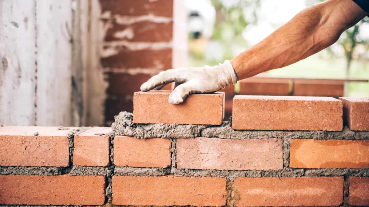 Person laying bricks.