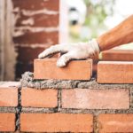 Person laying bricks.