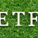 ETF written in white on a grass background.