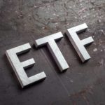 ETF written in white with a blackish background.