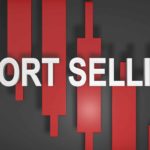 The words short selling in red against a black background