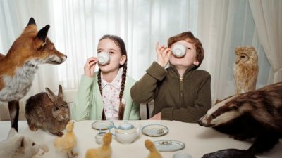 Nothing to see here, just a storm in a teacup as far as this boy and girl are concerned, sipping tea in their living room.