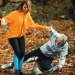 woman holding man's hand as he falls representing ups and downs of ASX investing