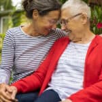 Senior woman with caregiver in the garden