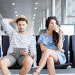 Couple at an airport waiting for their flight.