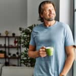 Middle age caucasian man smiling confident drinking coffee at home.