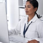 Cropped shot of an attractive young female scientist working on her computer in the laboratory.