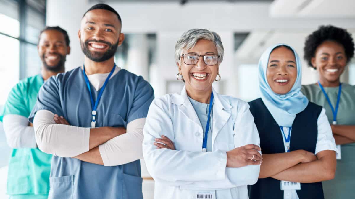 Portrait, confidence and team of doctors in the hospital standing after a consultation or surgery. Success, healthcare and group of professional medical workers in collaboration at a medicare clinic.