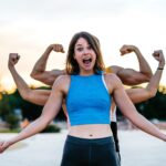 A fit woman in workout gear flexes her muscles with two bigger people flexing behind her, indicating growth.