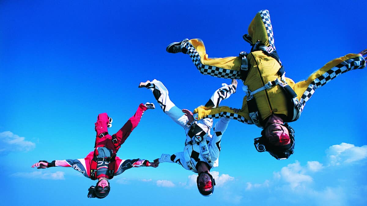 Three people skydiving.