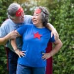 Elderly couple dressed up with capes on.