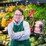 Man with down syndrome working in supermarket.