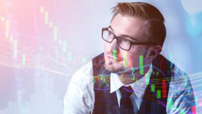 Businessman studying a high technology holographic stock market chart.