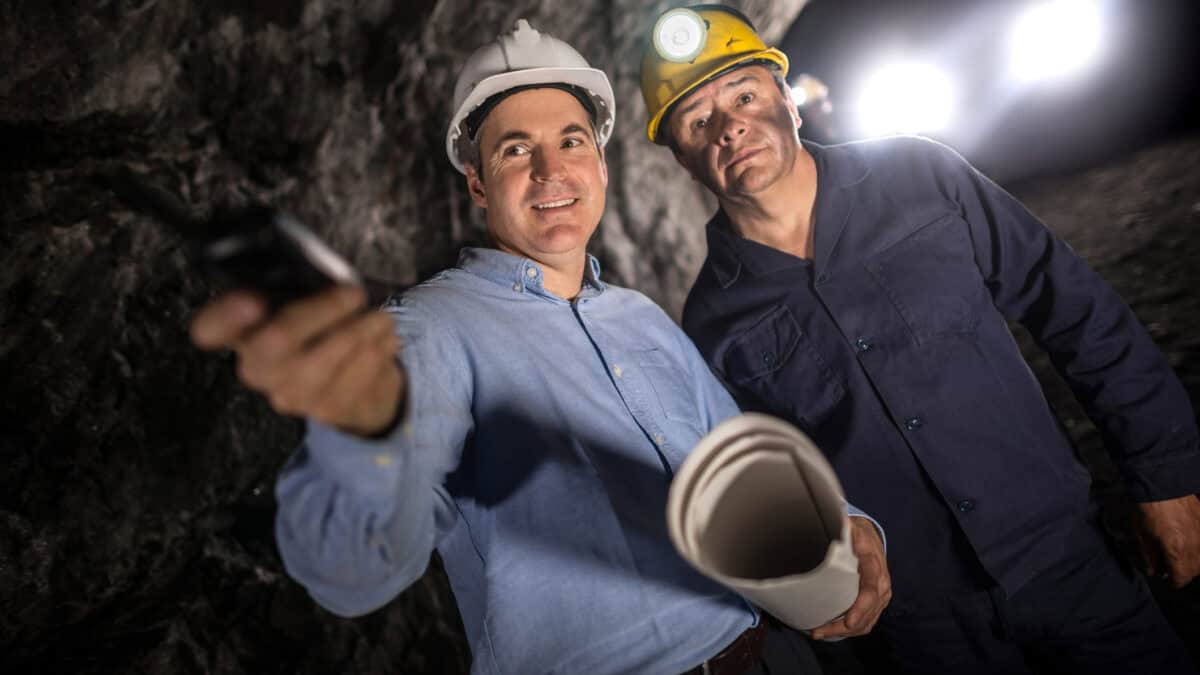 Engineer at an underground mine and talking to a miner.