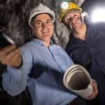 Engineer at an underground mine and talking to a miner.