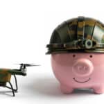 Piggybank with an army helmet and a drone next to it, symbolising a rising DroneShield share price.