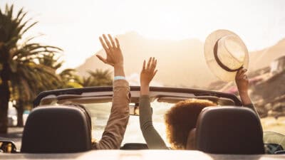 Happy young couple doing road trip in tropical city.