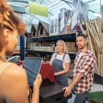 Young couple at the counter of a hardware store.