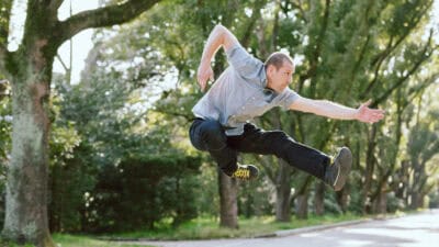 Man jumping in the air outside.