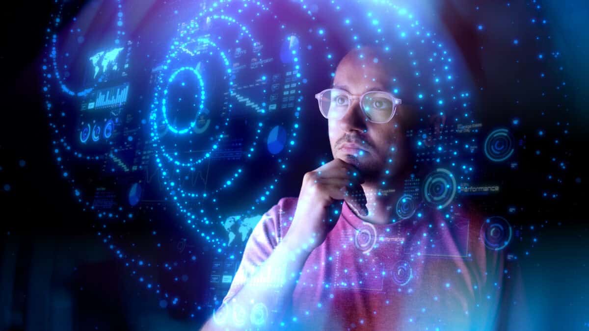 Man looking at digital holograms of graphs, charts, and data.